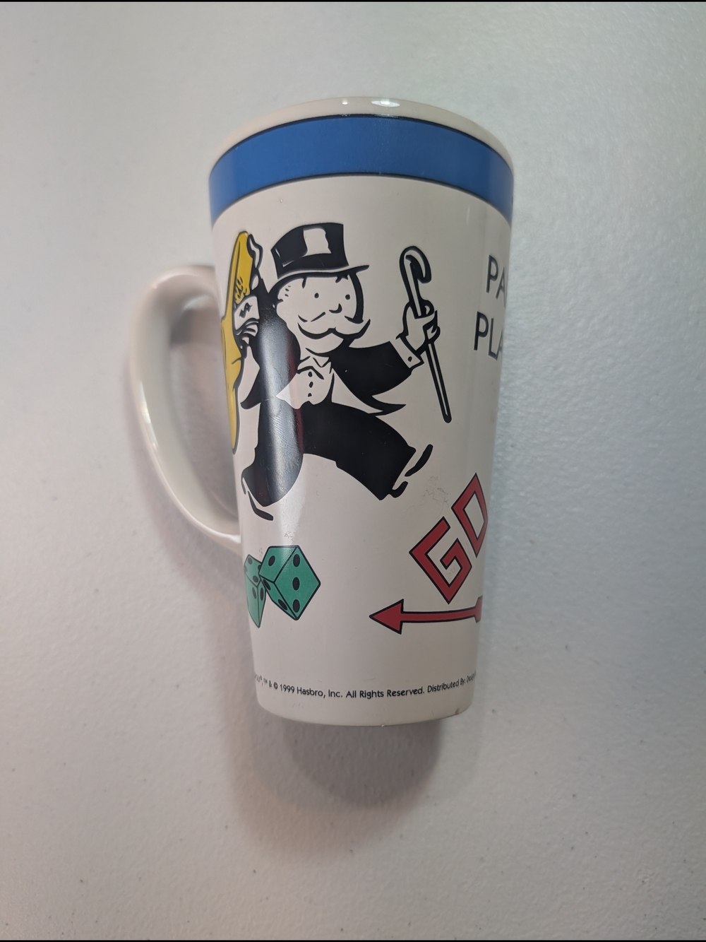 Monopoly-Themed White Ceramic Mug with Blue Rim
